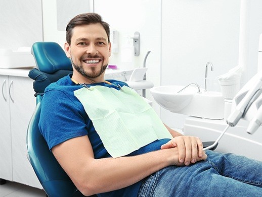 man laying back and smiling in exam chair