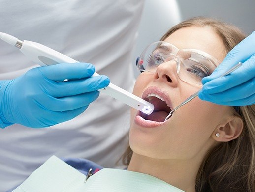 woman with intraoral camera in mouth