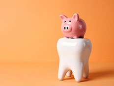 Pink piggy bank on large model tooth