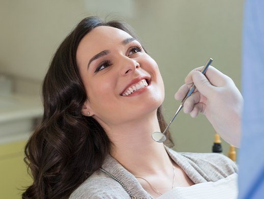 woman smiling up at dentist