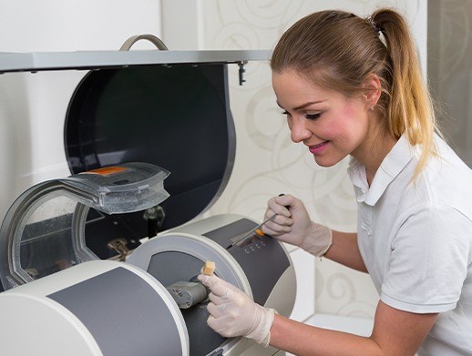 assistant working with cerec machine in lab