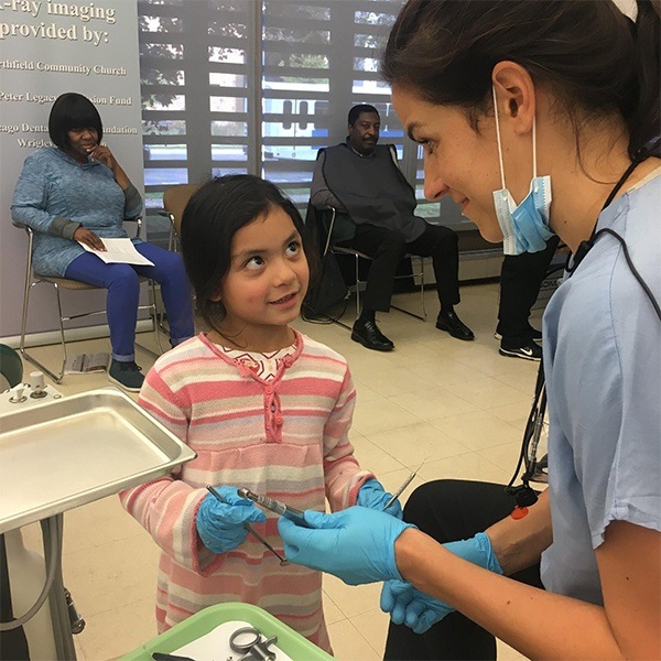 young patient smiling at assistant