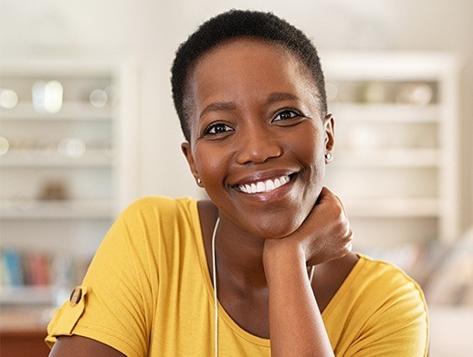 woman in yellow shirt with metal free dental crowns