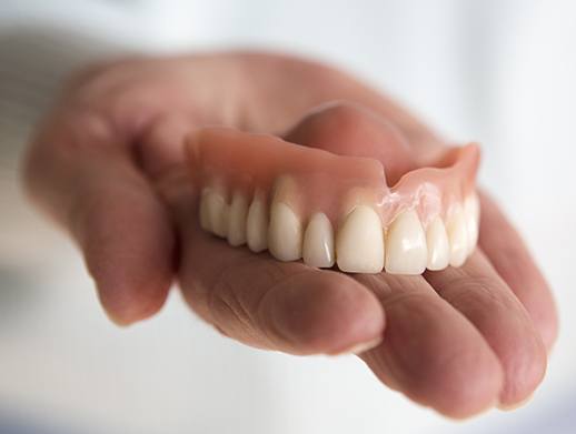 top denture in hand