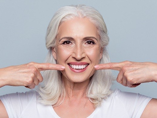 woman pointing to dentures