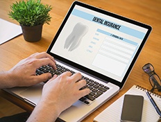 Smiling dental assistant showing patient forms