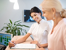 Man smiling at reflection in mirror in treatment chair