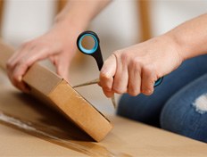 a person opening a package with scissors