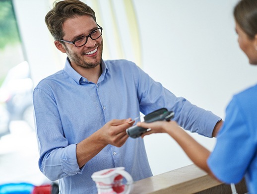 A man paying for dental treatment