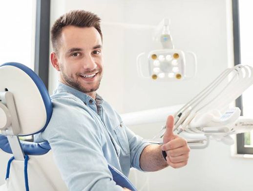 dental patient giving a thumbs up