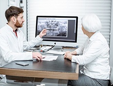 dentist showing a patient their dental X-rays