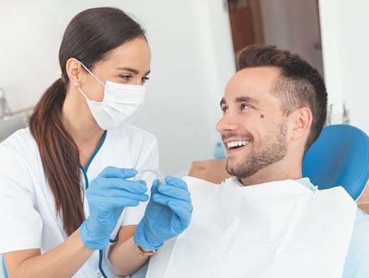 Man speaking to his Skokie cosmetic dentist about Invisalign in Skokie