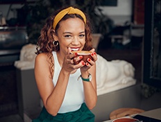 Woman smiling while enjoying cup of coffee