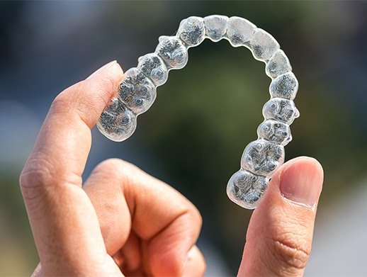 hand holding invisalign tray