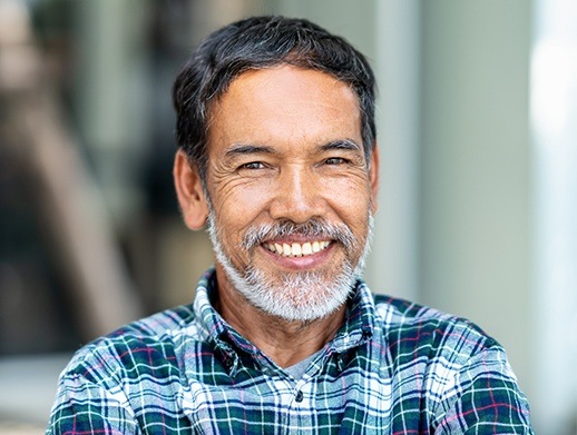 man smiling with dentures in