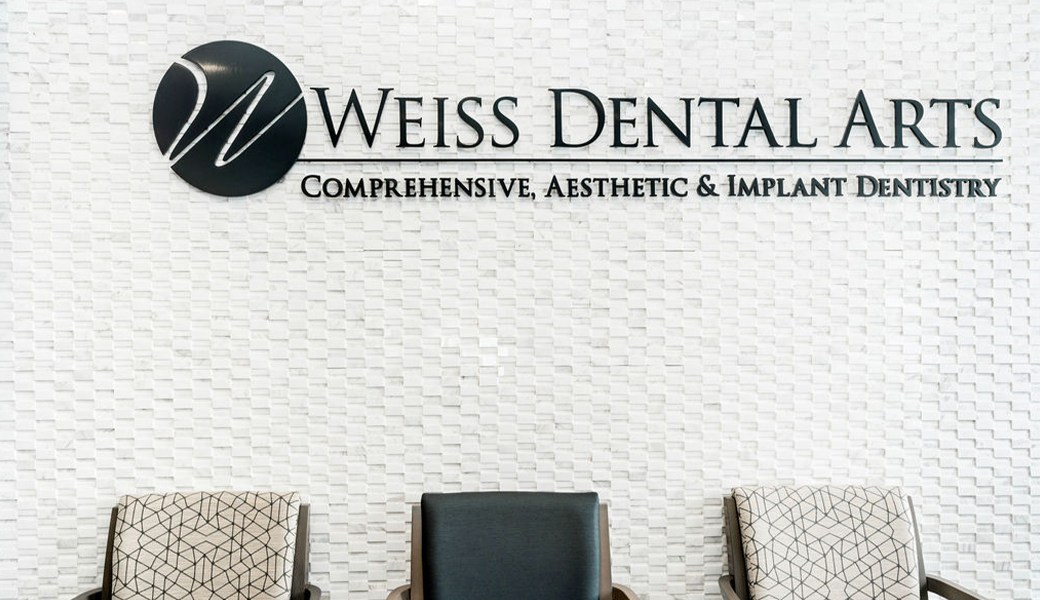 Weiss Dental Arts Comprehensive, Aesthetic & Implant Dentistry sign on dental office wall