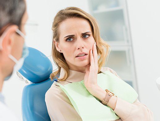 woman holding cheek with gum pain before periodontal thearpy