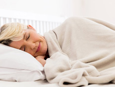 Woman sleeping peacefully in her bed 