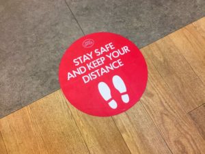 sticker on the floor as a reminder for social distancing in Skokie