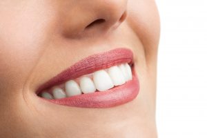 Close up of perfect female teeth on white background