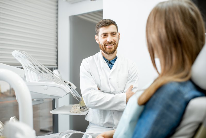 Dentist and patient talking during a dental implant consultation