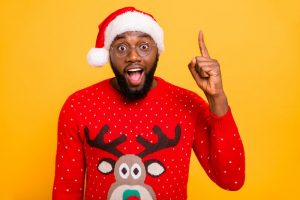 smiling man wearing santa hat