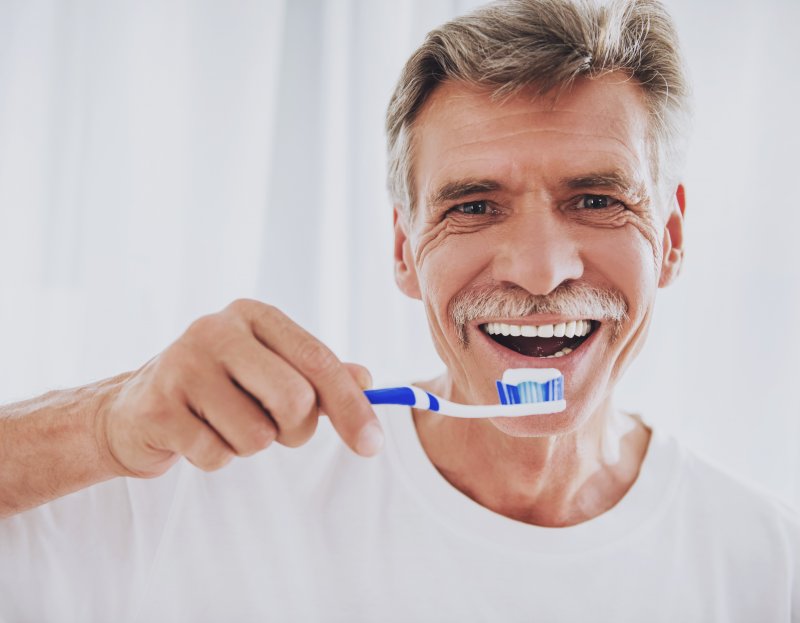 man brushing veneers in Skokie